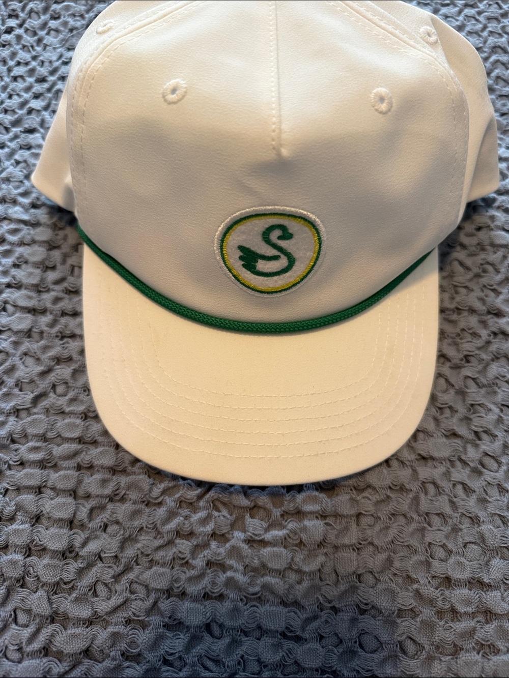 White woman's golf  Cap with Green Trim and Swan Logo.